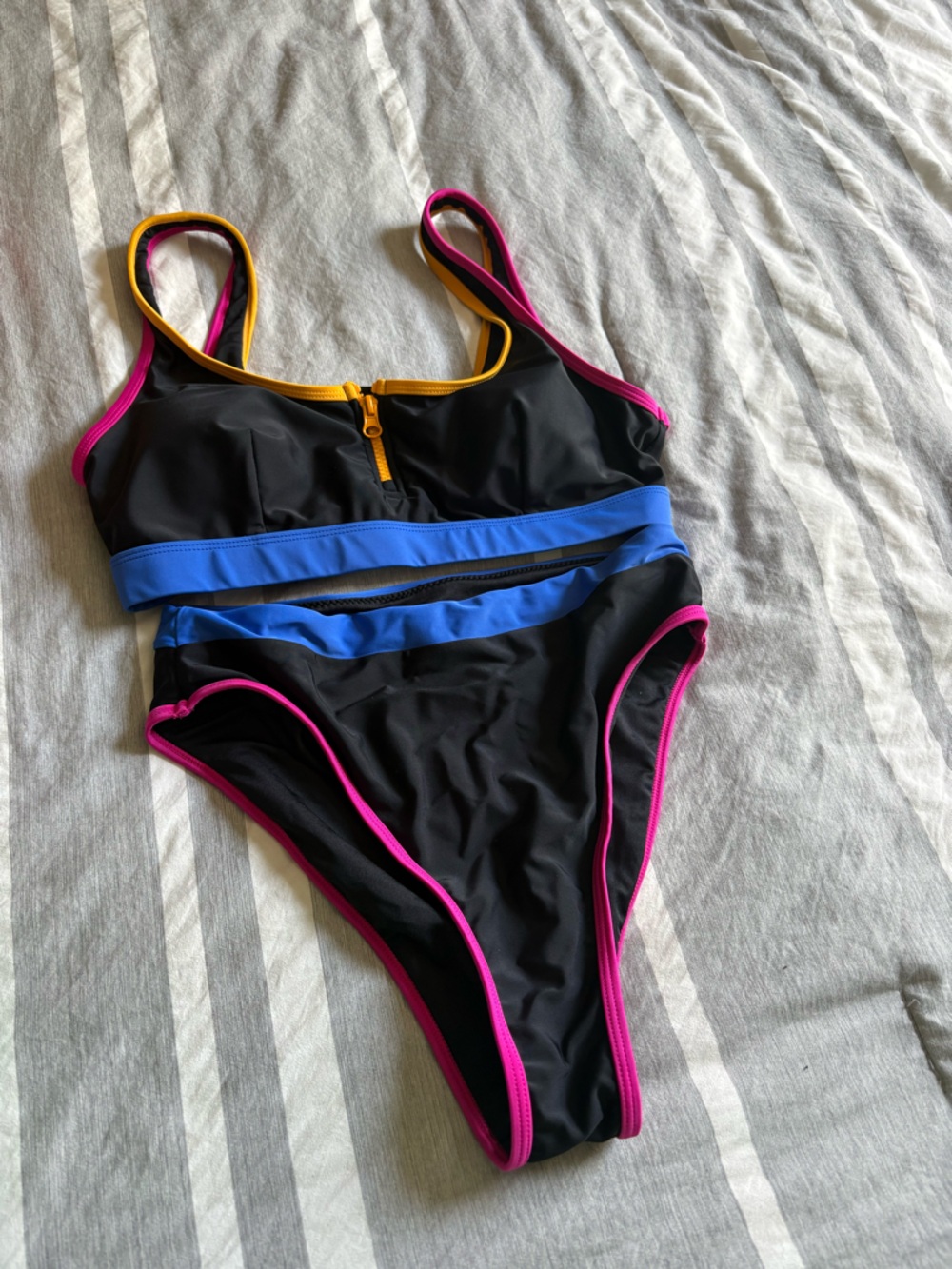 Black One-Piece Swimwear with Blue Stripes and Pink Trim